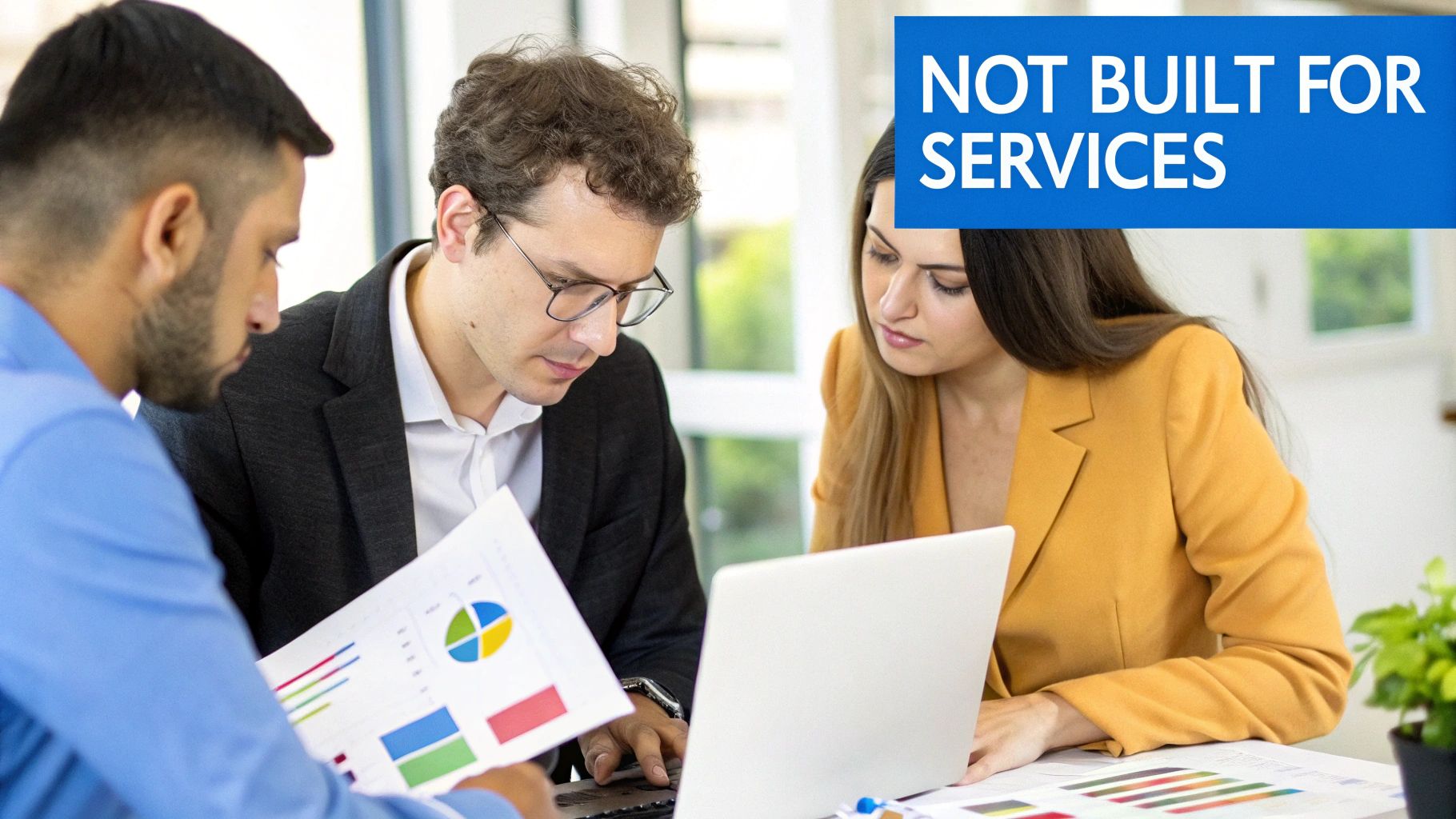 A group of professionals collaborating around a table with laptops and documents, representing a professional services team.