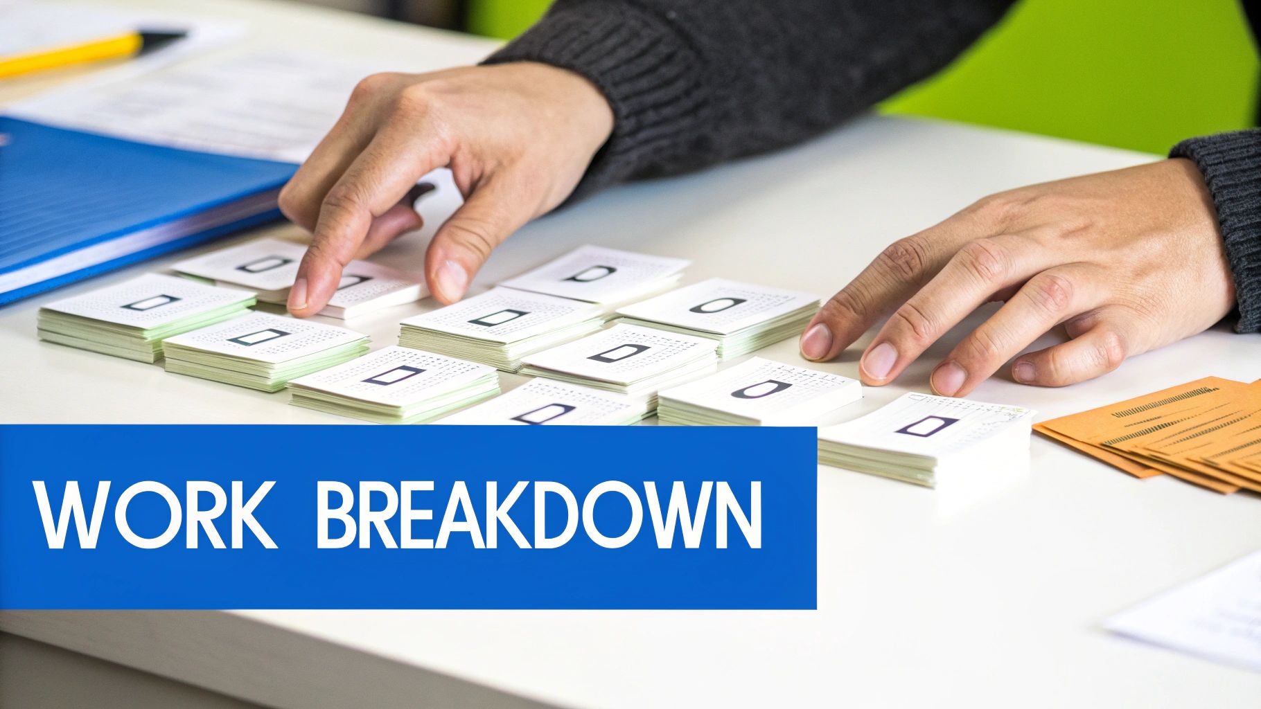 Hands arranging stacks of white cards on a table, illustrating work breakdown for project planning.